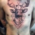 Sketch style black ink chest tattoo of mystic deer with geometrical ornaments