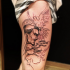 Sketch style black ink thigh tattoo of man face with lettering and pigeon