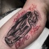 Sketch style colored biceps tattoo of modern car with lettering
