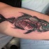 Sketch style colored biceps tattoo of X-Ray like fish