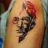 Sketch style colored shoulder tattoo of Lennon face