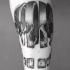 Sliced human skull pieces tattoo in engraving style with dotted work and volume details