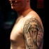 Small black and white antic statue tattoo on shoulder with lettering