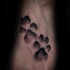 Small black ink animal paw prints