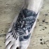 Small black ink engraving style demon with hammerhead shark tattoo on foot