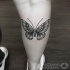 Small black ink leg tattoo of beautiful butterfly