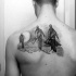 Small black ink scapular tattoo of