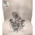 Small black ink waist tattoo of bird with flowers