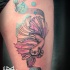 Small cartoon style thigh tattoo of cute fish