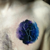 Small colored chest tattoo of star figure in dark sky