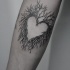 Small heart shaped arm tattoo of tree branches