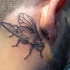 Small homemade style black ink head tattoo of small fly