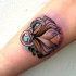 Small neo traditional style arm tattoo of old book