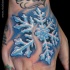 Sparkling like colored detailed snowflake tattoo on hand with lettering