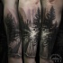 Spectacular black and white forest sunrise tattoo on forearm