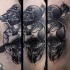 Spectacular black and white human skull with crow tattoo on arm