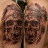Spectacular black and white shoulder tattoo of human skull with feather and ornaments