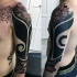 Spectacular blackwork style sleeve tattoo stylized with flowers