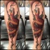 Spectacular colored arm tattoo of evil snake with leaves