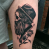 Spectacular engraving style thigh tattoo of surrealism man portrait and rose