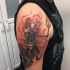 Spectacular illustrative style cartoon like devil tattoo on shoulder stylized with human skull