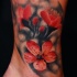 Spectacular looking colored ankletattoo of beautiful flower
