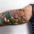 Spectacular looking colored biceps tattoo of Toy Story cartoon heroes