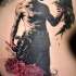 Spectacular looking colored tattoo of maniac with roses and crow