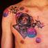 Spectacular looking colorful chest tattoo of planets with spacesuit