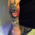 Spectacular multicolored forearm tattoo of Batman with lettering