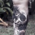 Spectacular realism style black ink leg tattoo of human skull