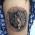Stippling style black and white thigh tattoo of black panther and leopard