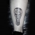 Stippling style black ink ankle tattoo of bulb with sailing ship
