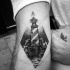 Stippling style black ink biceps tattoo of lighthouse and waves