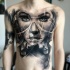 Stippling style black ink chest tattoo of woman with skull