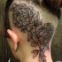 Stippling style black ink head tattoo of large flowers