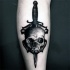 Stippling style black ink leg tattoo of human skull with dagger