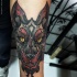 Stippling style colored arm tattoo of demonic wolf