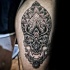 Stippling style colored leg tattoo of human skull with ornaments