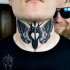 Stippling style colored neck tattoo of butterfly