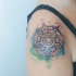Stippling style colored shoulder tattoo of illustrative flower