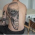 Stippling style large human skull tattoo on half back