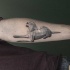 Stone like black ink arm tattoo of big dog