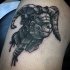 Stonework style black and white thigh tattoo of big goat head