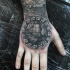 Stonework style black ink hand tattoo of strange looking planet