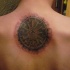Stonework style colored upper back tattoo of ancient tablet