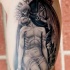 Stonework style detailed biceps tattoo of angel skeleton with human