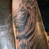 Stonework style forearm tattoo of lion statue