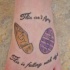 Strange designed colored little emblems tattoo on foot stylized with lettering