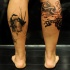 Strange looking black ink leg tattoo